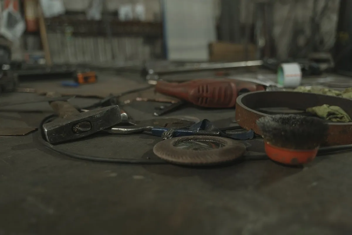 A variety of tools scattered on a workbench, highlighting the equipment needed for garage door repairs.